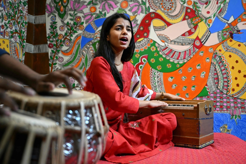 In this photograph taken on April 2, 2024, Indian folk singer Maithili Thakur sings after an interview with AFP at her residence in New Delhi. — AFP pic