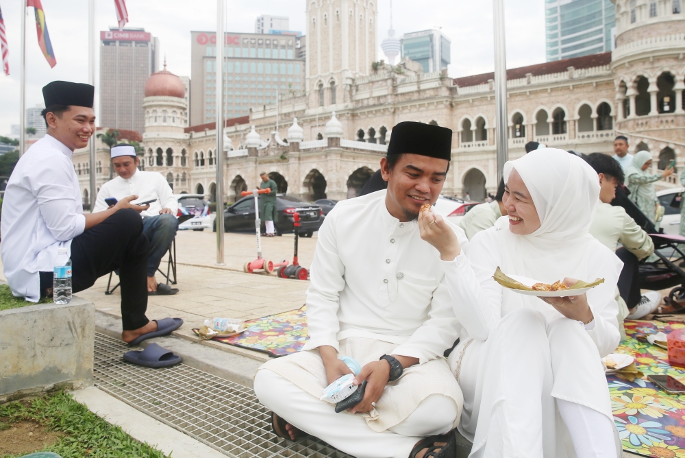 The newlywed couple celebrating Hari Raya Aidilfitri at Dataran Merdeka in Kuala Lumpur April 10, 2024. 