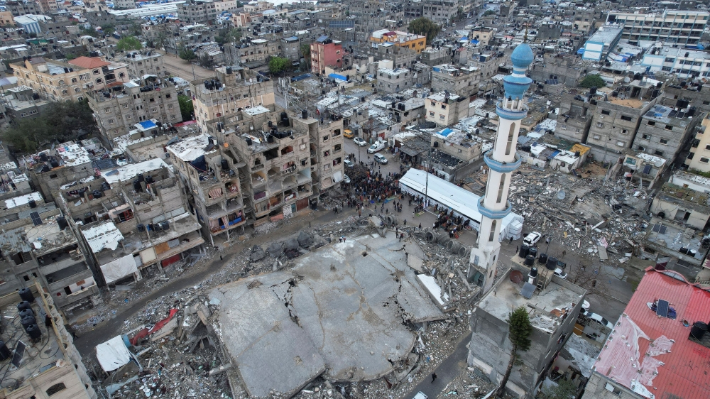 A drone view shows Palestinians holding Eid al-Fitr prayers by the ruins of al-Farouk mosque. — Reuters pic