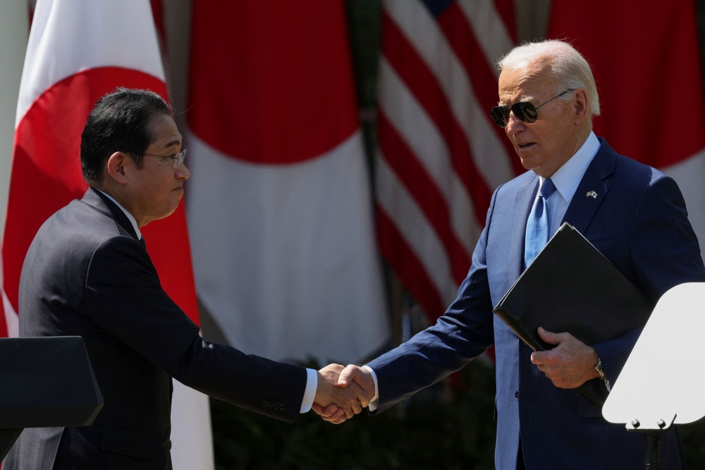 US President Joe Biden shake hands with Japanese Prime Minister Fumio Kishida following a joint press conference in the Rose Garden at the White House in Washington April 10, 2024. — Reuters pic