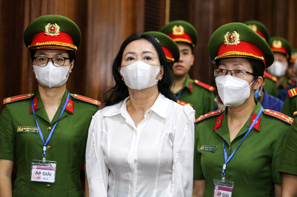 Vietnam's property tycoon Truong My Lan (centre) arrives at a court in Ho Chi Minh city March 5, 2024. — AFP pic