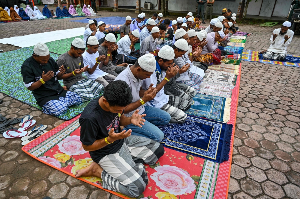 Rohingya refugees take part in Eid al-Fitr prayers, marking the end of the holy month of Ramadan, at a temporary shelter in Meulaboh, Indonesia's Aceh province April 10, 2024. — AFP pic