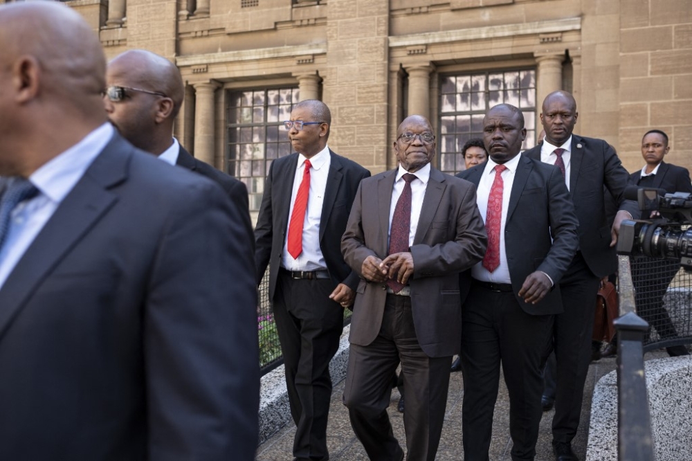 Former South African President Jacob Zuma (centre) walks out of court after the private prosecution trial, where Zuma is suing South African President Cyril Ramaphosa over a leaked medical report linked to a 1990s arms corruption trial, in Johannesburg on April 11, 2024. — AFP pic