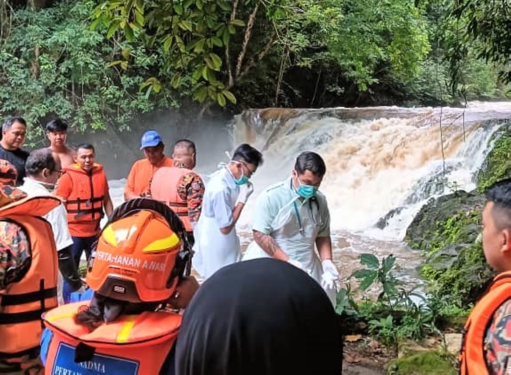 The Bomba rescue team are pictured at the waterfall at Kampung Sebat Dayak April 11, 2024. — Picture by Bomba Lundu station