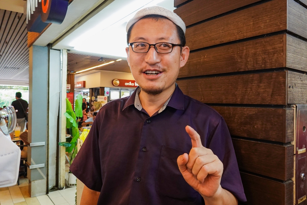 Despite saying he did not receive any discounts for his Menu Rahmah meals, stall owner Ishaq Qin said he would continue offering these as it was important for low-income earners. — Picture by Miera Zulyana