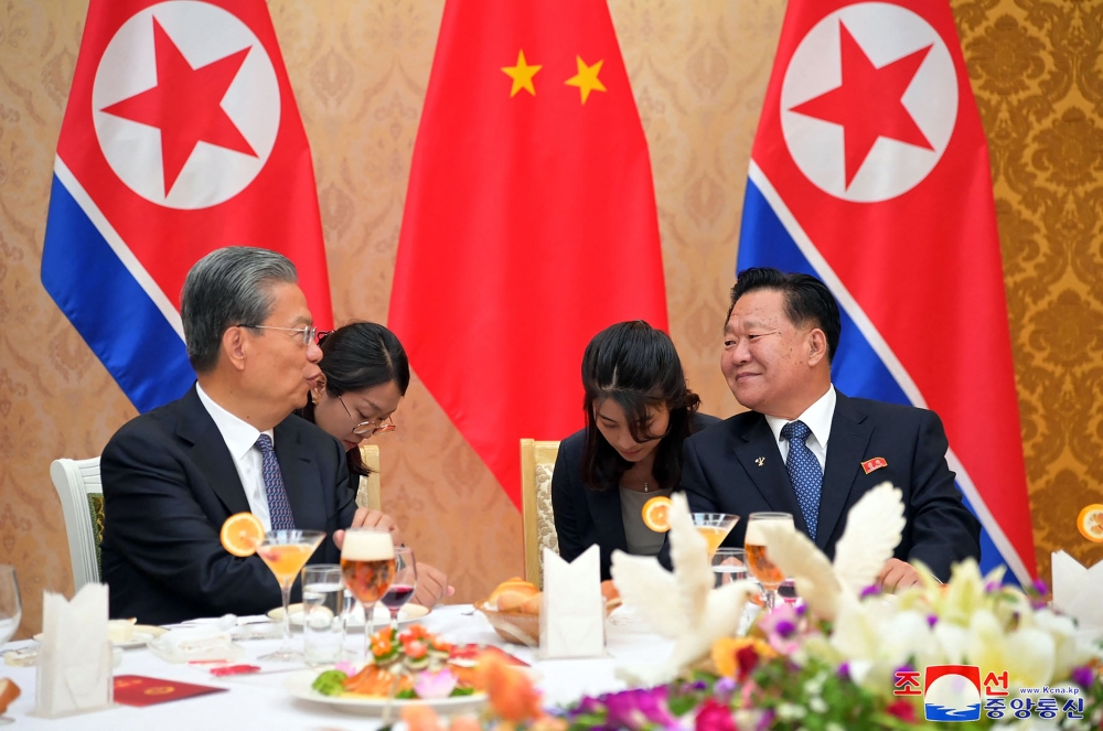 This picture taken on April 11, 2024 and released from North Korea's official Korean Central News Agency (KCNA) via KNS on April 12, 2024 shows China's top lawmaker Zhao Leji (left) chatting with Choe Ryong Hae (right), chairman of North Korea's Standing Committee of the Supreme People's Assembly, during a welcoming banquet for Zhao's delegation in Pyongyang. — Picture by KCNA VIA KNS/AFP