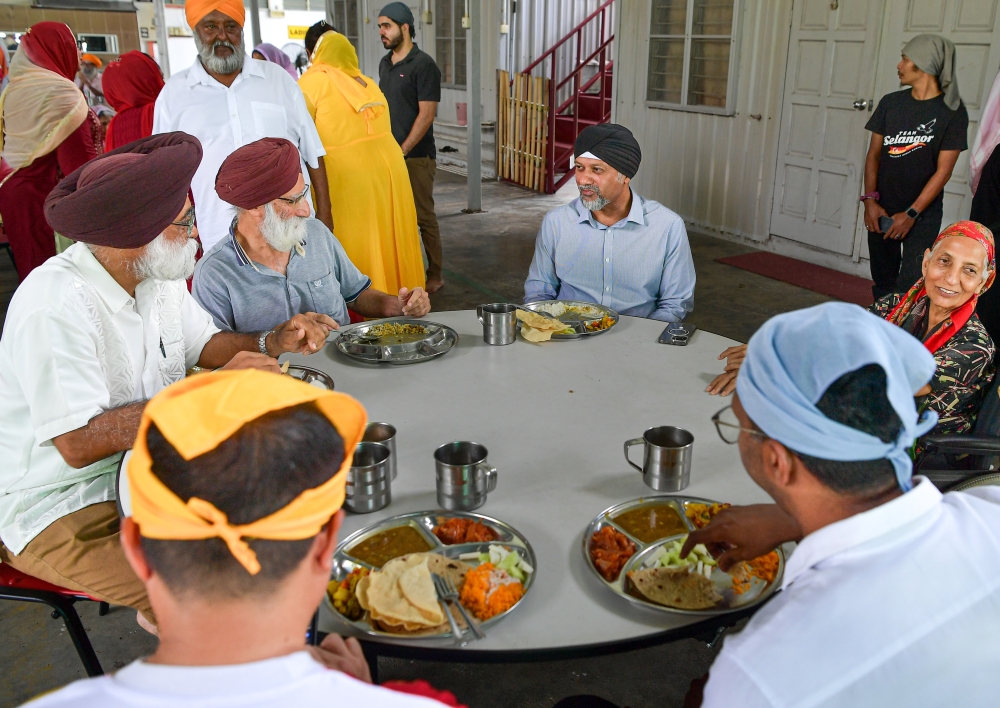 DAP national deputy chairman Gobind Singh Deo (centre) speaks to people at the Vaisakhi Day celebrations at the Khalsa Land Gurdwara Sahib Community Centre in Kuala Kubu Baru April 13, 2024. — Bernama pic