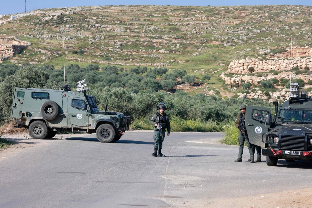 Israeli security forces man a checkpoint during a search for a missing Israeli teenager in the village of Mughayir near Ramallah in the Israeli-occupied West Bank on April 13, 2024. — AFP pic