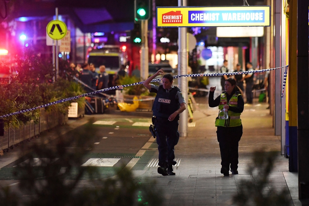 Emergency service workers walk near Bondi Junction after multiple people were stabbed inside the Westfield Bondi Junction shopping centre in Sydney, April 13, 2024. — Reuters pic