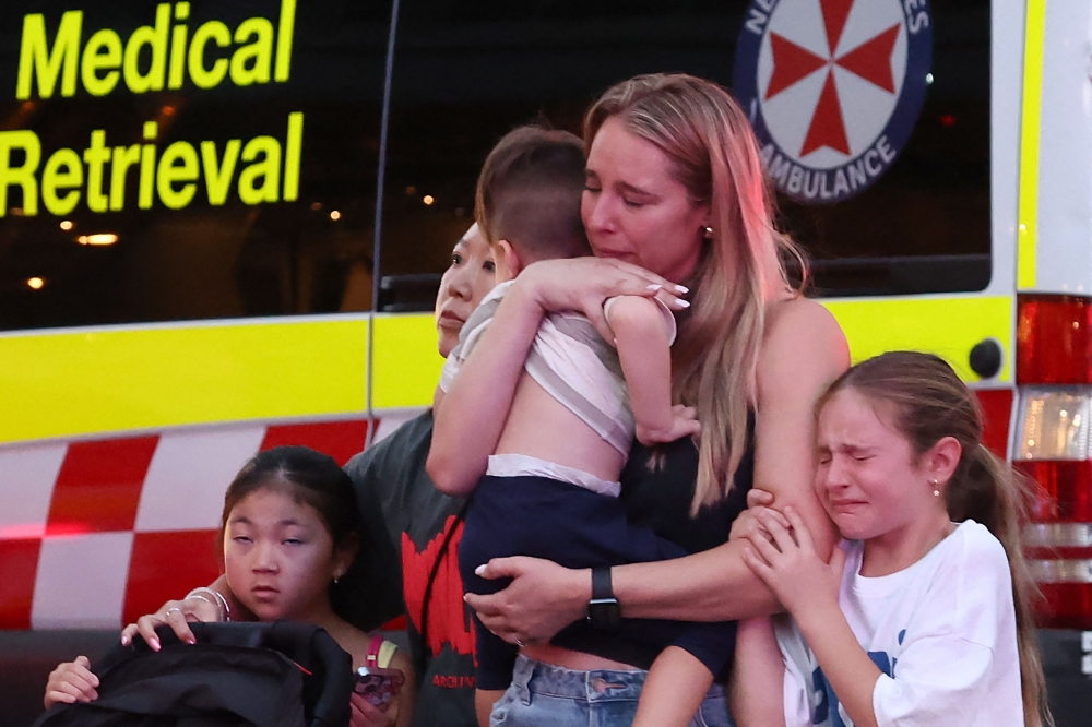 A family leaves the Westfield Bondi Junction shopping mall after a stabbing incident in Sydney on April 13, 2024. — AFP pic