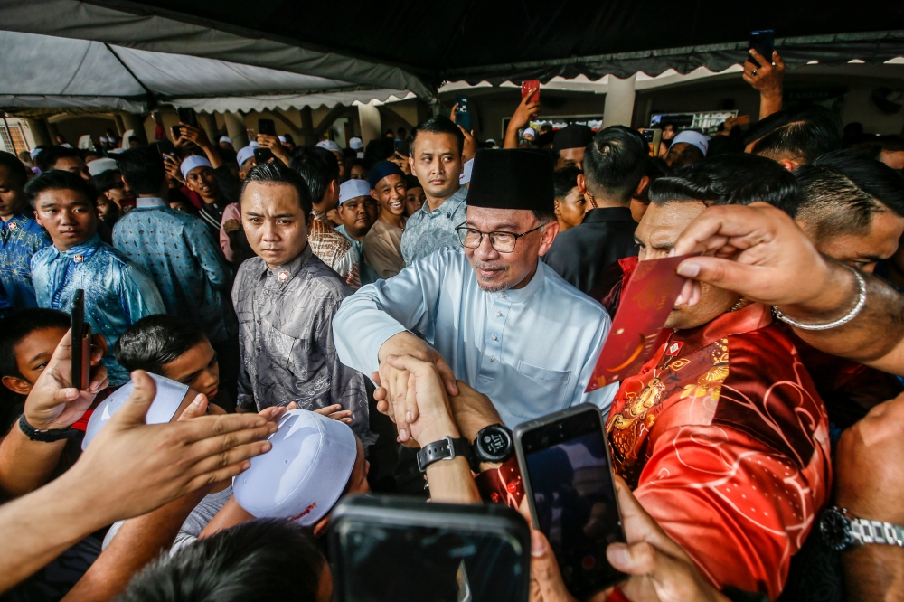 Prime Minister Datuk Seri Anwar Ibrahim (centre) greets members of the public after Friday prayers at Masjid Bandar Utama Batang Kali in Hulu Selangor April 12, 2024. — Picture by Hari Anggara