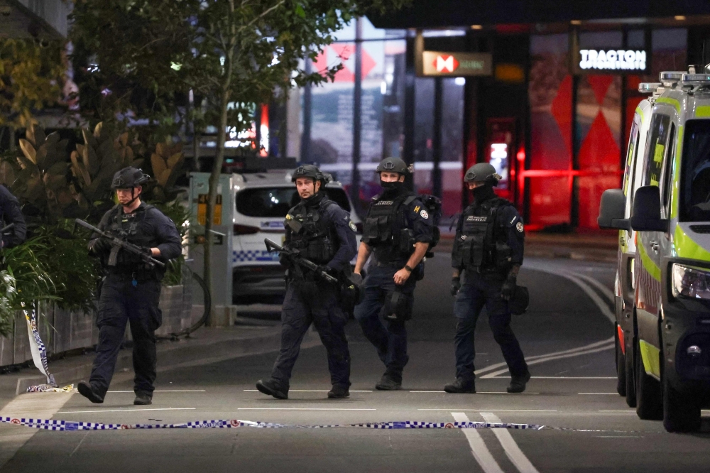 Police patrol in front of the Westfield Bondi Junction shopping mall after a stabbing incident in Sydney on April 13, 2024. — AFP pic