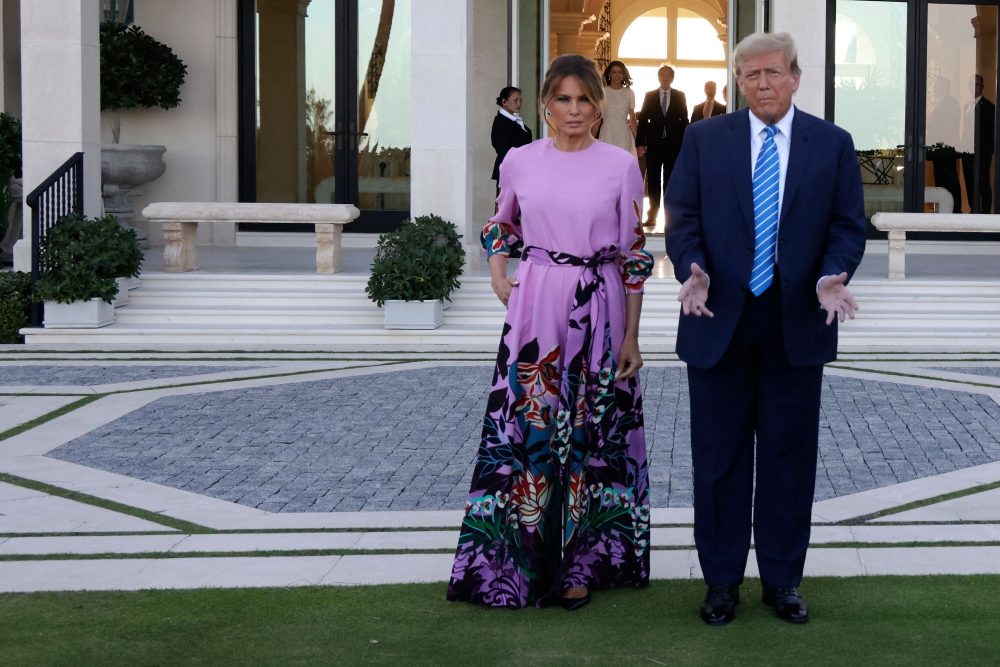 File photo of Republican presidential candidate, former US President Donald Trump and former first lady Melania Trump arriving at the home of billionaire investor John Paulson on April 6, 2024 in Palm Beach, Florida. — AFP pic