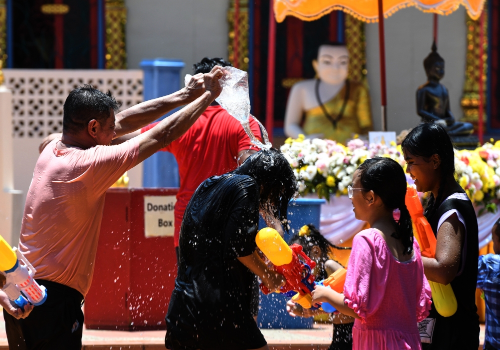 People celebrate the Songkran festival in George Town April 14, 2024. — Bernama pic