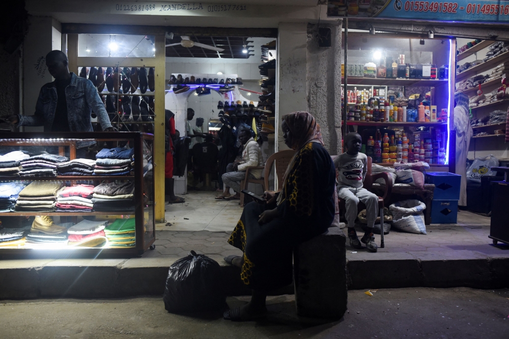 A woman sits outside Sudanese shops in Cairo, Egypt, April 9, 2024. — Reuters pic