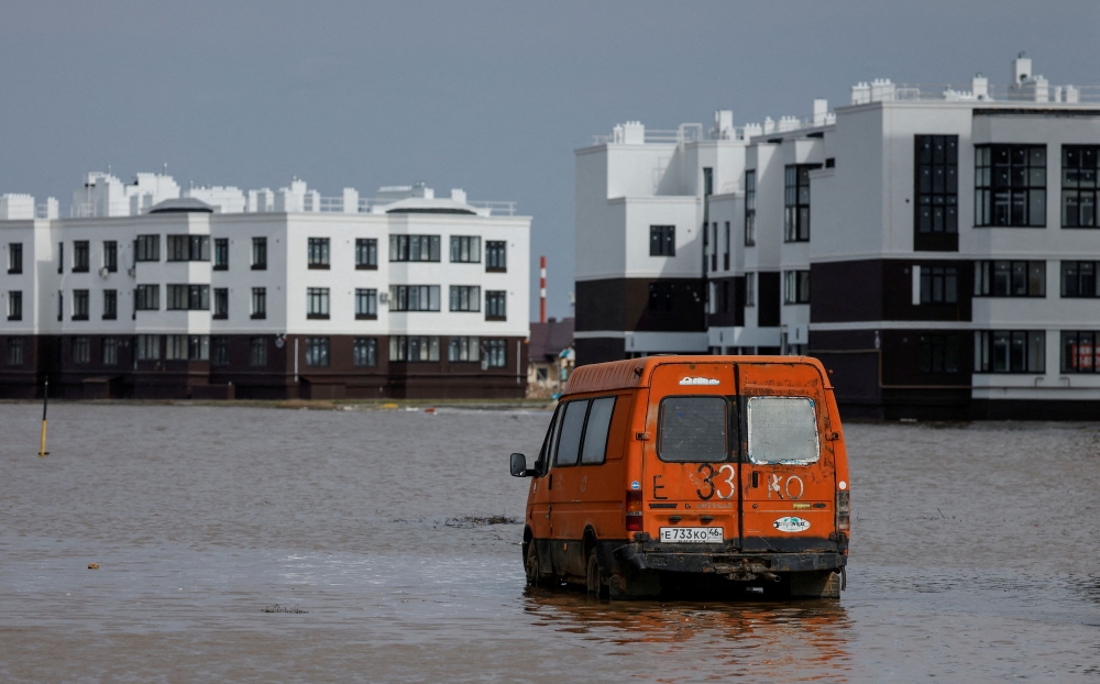 A view shows a minibus on a flooded street in Orenburg, Russia, April 12, 2024. — Reuters pic