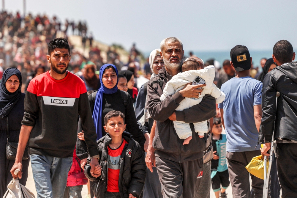 Thousands of Gazans flooded the coast road north yesterday after hearing that several people managed to cross a closed checkpoint towards Gaza City, despite Israel denying it was open. — AFP pic