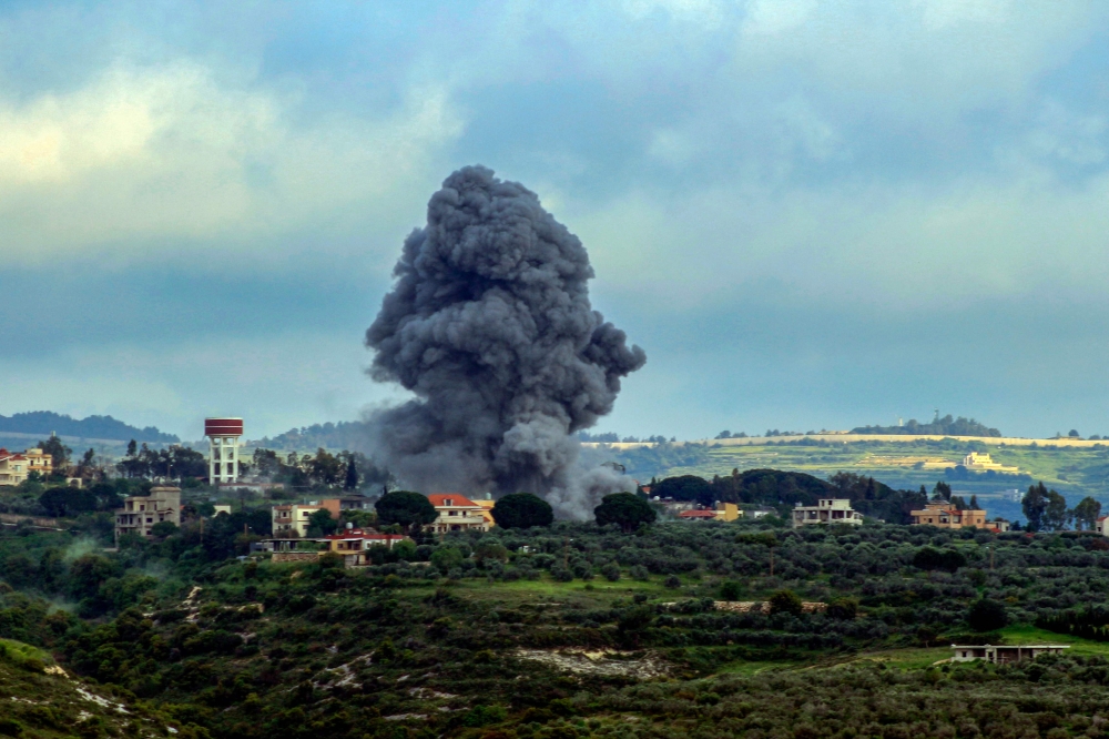 Smoke billows after an Israeli strike on the southern Lebanese border village of Tayr Harfa on April 13, 2024. — AFP pic
