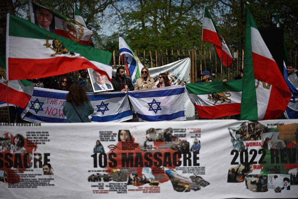 An anti-Iranian demonstration is held outside the Iranian Embassy in London on April 14, 2024. — AFP pic