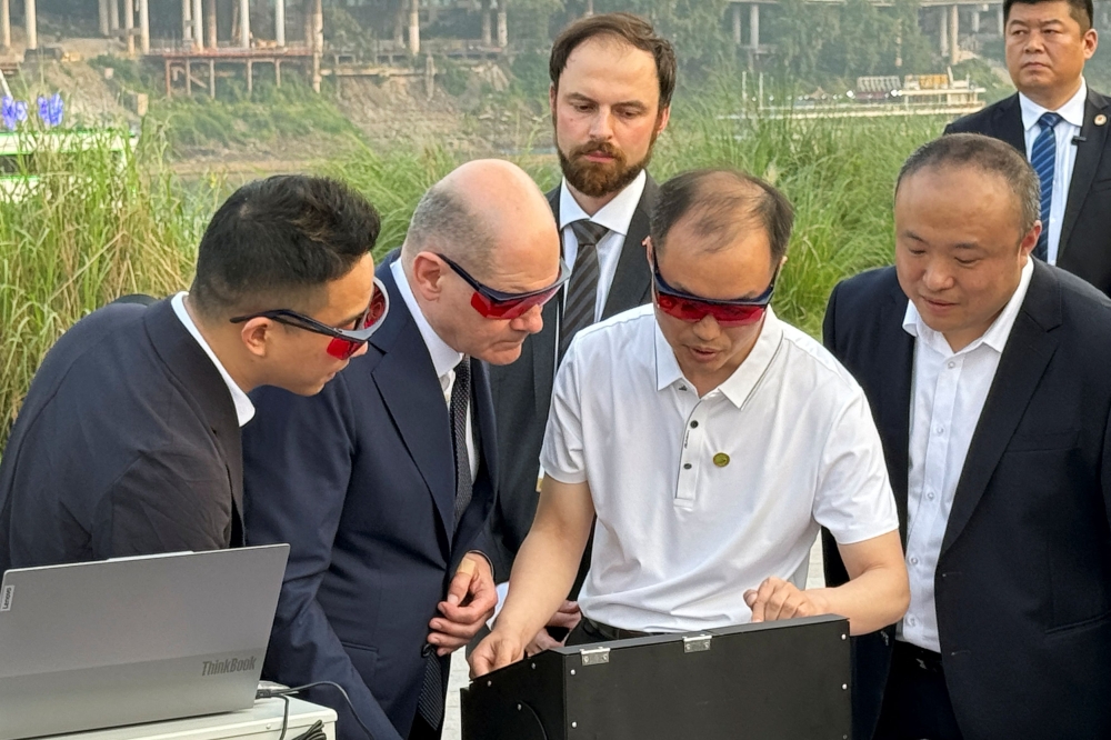 German Chancellor Olaf Scholz visits a research project on the monitoring of water quality in Chongqing, China April 14, 2024. — Reuters pic