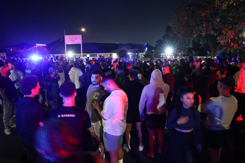 Locals gathered outside the church. — AFP pic