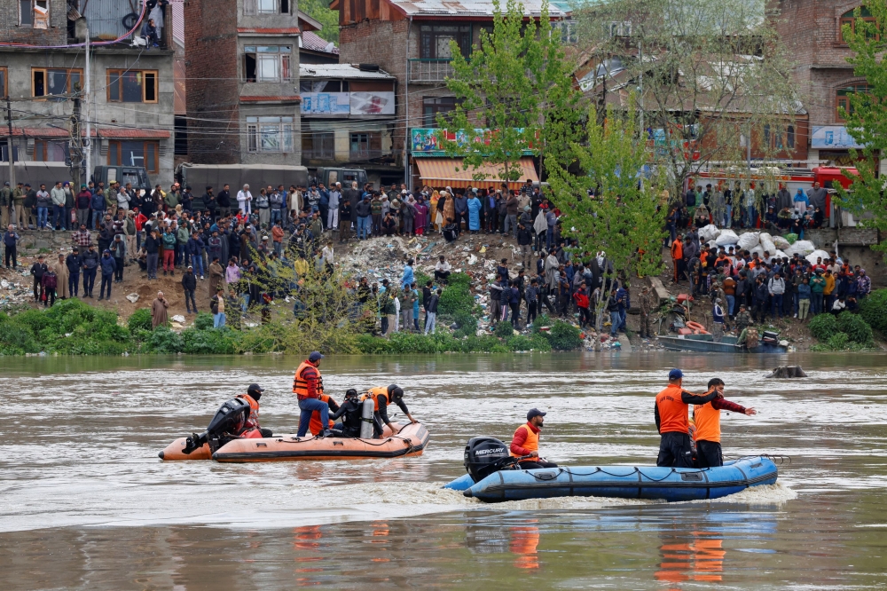 Rescuers in rubber boats joined by marine commandos were scrambling to find survivors as hundreds of worried and mourning family members gathered at the riverbanks after the accident. — Reuters pic