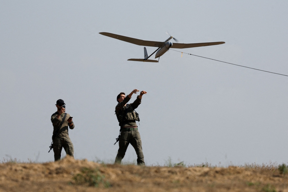 Israeli soldiers fly a drone near the Israel-Gaza border, amid the ongoing conflict between Israel and the Palestinian Islamist group Hamas, in Israel, April 15, 2024. — Reuters pic