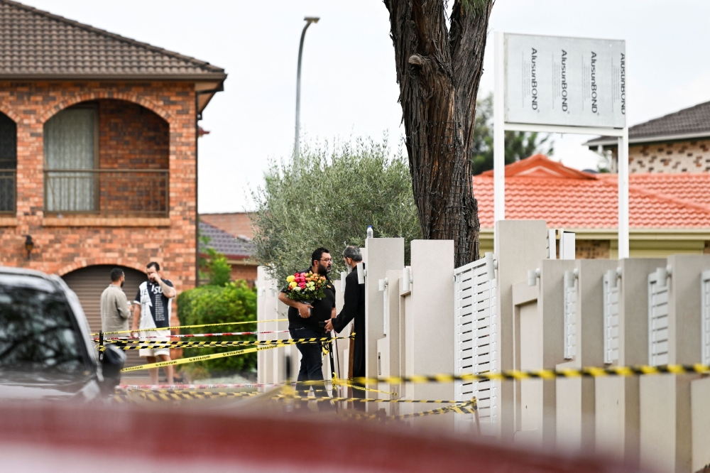 A man is greeted by a clergyman outside the Assyrian Christ The Good Shepherd Church after a knife attack took place during a service on Monday night, in Wakely in Sydney, Australia, April 17, 2024. — Reuters pic