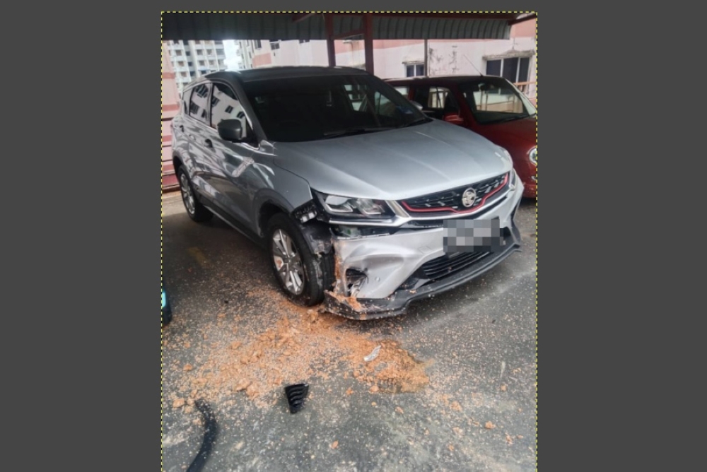 A photograph shows a vehicle damaged by the blast. — Picture by Ronnie Lim Hai Seng