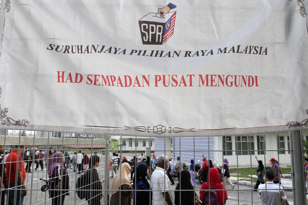 File picture of Malaysian voters waiting outside a polling centre for the 14th General Election (GE14) in Kuala Lumpur, Malaysia on May 9, 2018. The Ipsos poll found that public sentiment about the country began to decrease in 2023 after an initial high in January 2023 following the GE14. — Picture by Miera Zulyana
