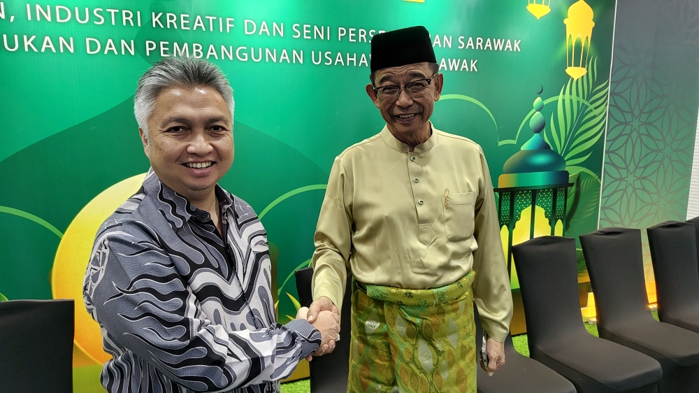 Sarawak Tourism, Creative Industry and Performing Arts Minister Datuk Seri Abdul Karim Rahman Hamzah (right) welcomes his deputy, Datuk Snowdan Lawan, to his Hari Raya Aidilfitri open house in Kuching April 18, 2024. — Picture by Sulok Tawie