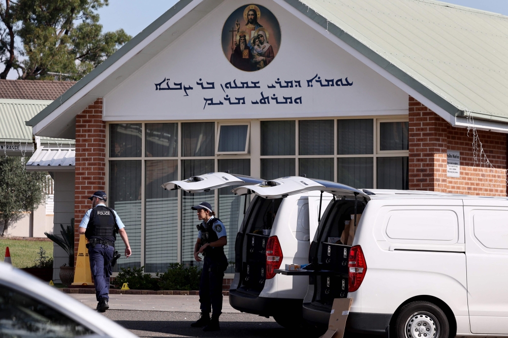 Police officers and their vehicles can be seen outside the Christ the Good Shepherd Church in Sydney's western suburb of Wakeley on April 16, 2024. — AFP pic