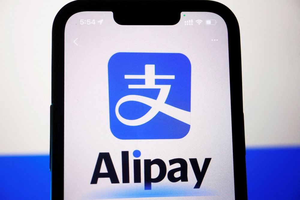 The logo of Alipay is seen through the camera of the app on a mobile phone, in this illustration picture taken June 28, 2023. — Reuters pic  