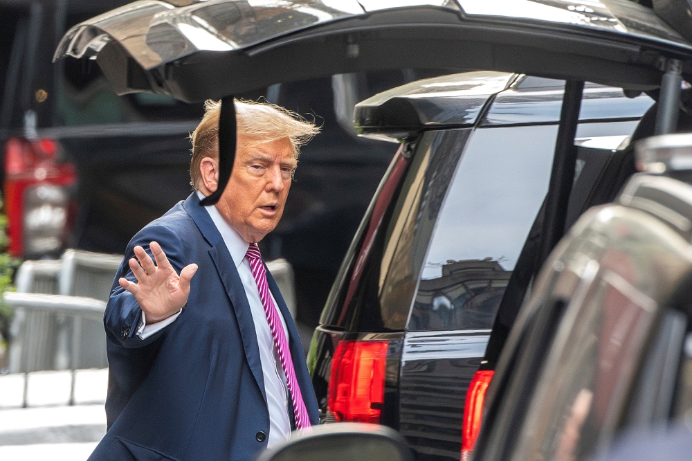 Republican presidential candidate and former U.S. President Donald Trump waves to people as he departs on the day of his trial over charges that he falsified business records to conceal money paid to silence porn star Stormy Daniels in 2016, outside Trump Tower, in New York City April 19, 2024. — Reuters pic  
