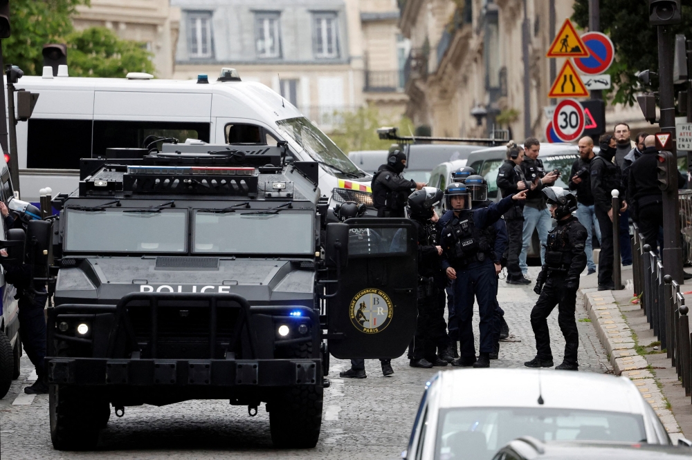 French police and members of French special police forces of Research and Intervention Brigade (BRI) secure the area near Iran consulate where a man is threatening to blow himself up, in Paris April 19, 2024. — Reuters pic  
