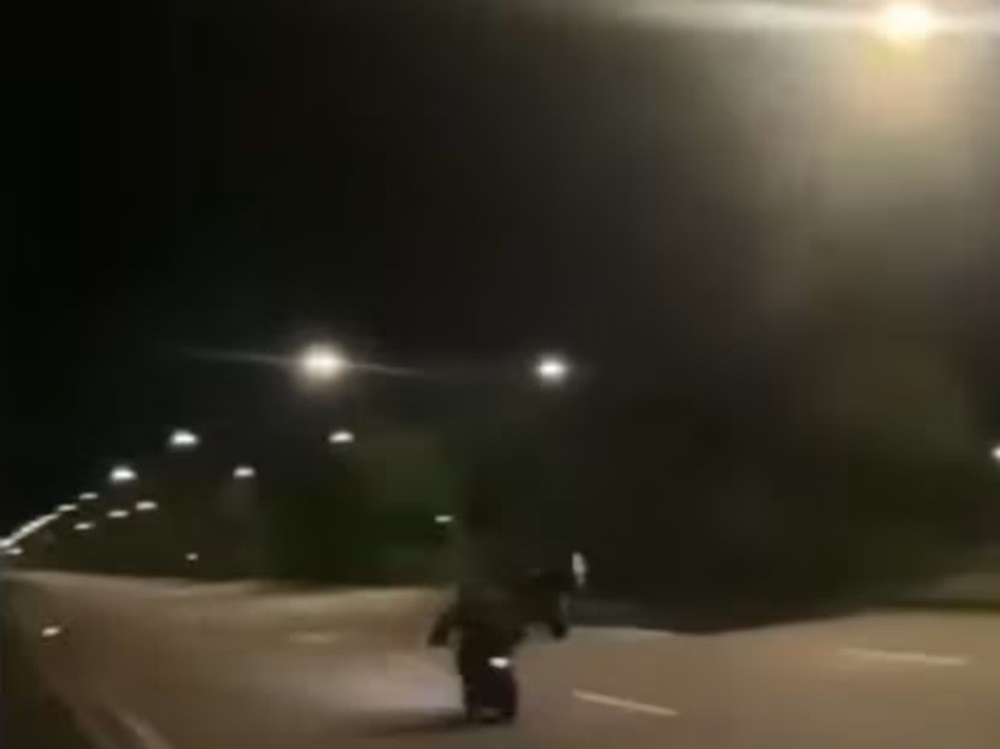 A screengrab from a video clip showing riders of power-assisted bicycles racing each other on an empty stretch of road. ― Picture via Facebook/SG Road Vigilante