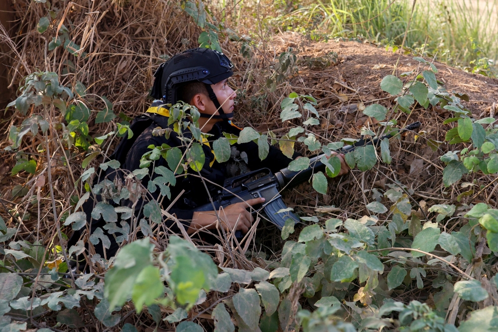 A Thai soldier takes cover near the 2nd Thailand-Myanmar Friendship Bridge during fighting on the Myanmar side between the Karen National Liberation Army and Myanmar’s troops, which continues near the Thailand-Myanmar border, in Mae Sot, Tak Province, Thailand, April 20, 2024. ― Reuters pic