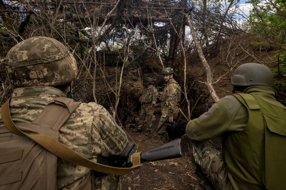 Ukrainian servicemen of the 22nd Separate Mechanised Brigade stand near a self-propelled howitzer at an artillery position, amid Russia’s attack on Ukraine, on the outskirts of Chasiv Yar, Ukraine, April 19, 2024. ― Reuters pic