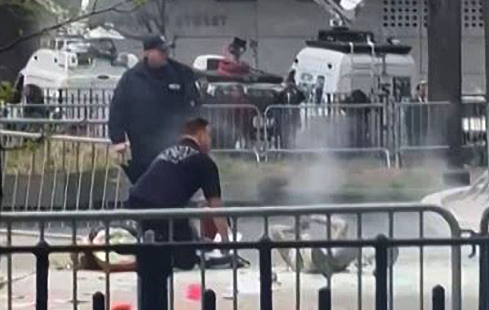 File photo of New York police officers next to a man after he set himself on fire, at the park across from Manhattan Criminal Court in New York City during the trial of US President Donald Trump, in New York, on April 19, 2024. ― AFP pic