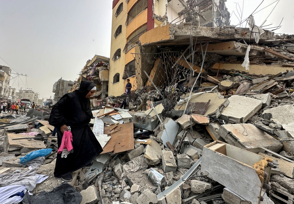 File photo of a Palestinian woman searching for her belongings after her apartment was destroyed in an Israeli raid, amid the ongoing conflict between Israel and the Palestinian Islamist group Hamas, in Nuseirat, in the central Gaza Strip, April 18, 2024. ― Reuters pic