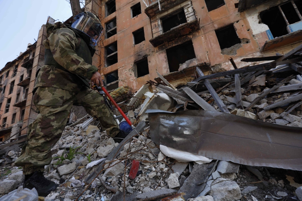 A Russian sapper checks a ruined building in Mariupol, in Russian-controlled Ukraine, on April 19, 2024 amid the Russia-Ukraine conflict. ― AFP pic