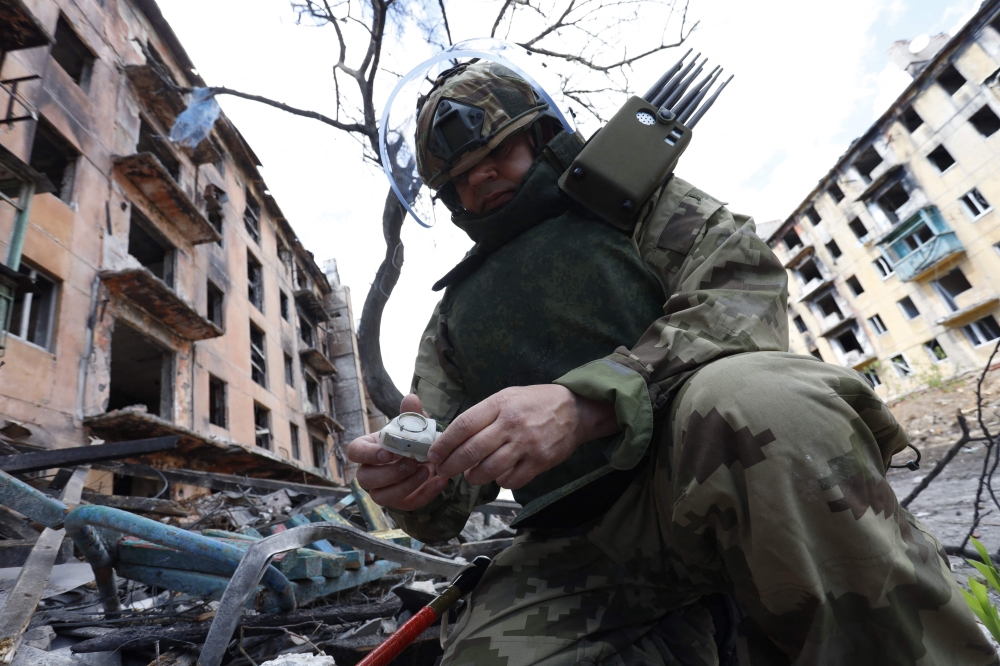 A Russian sapper checks a ruined building in Mariupol, in Russian-controlled Ukraine, on April 19, 2024 amid the Russia-Ukraine conflict. ― AFP pic