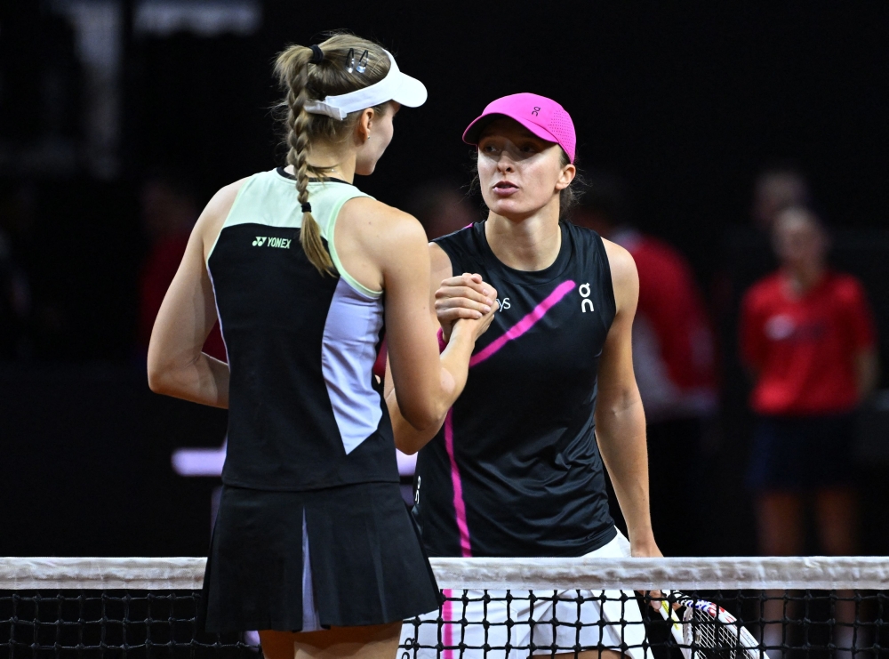 Kazakhstan’s Elena Rybakina shakes hands with Poland’s Iga Swiatek after winning her semi final match at the Stuttgart Tennis Grand Prix at the Tennis Club Weissenhof in Stuttgart, Germany, April 20, 2024. ― Reuters pic