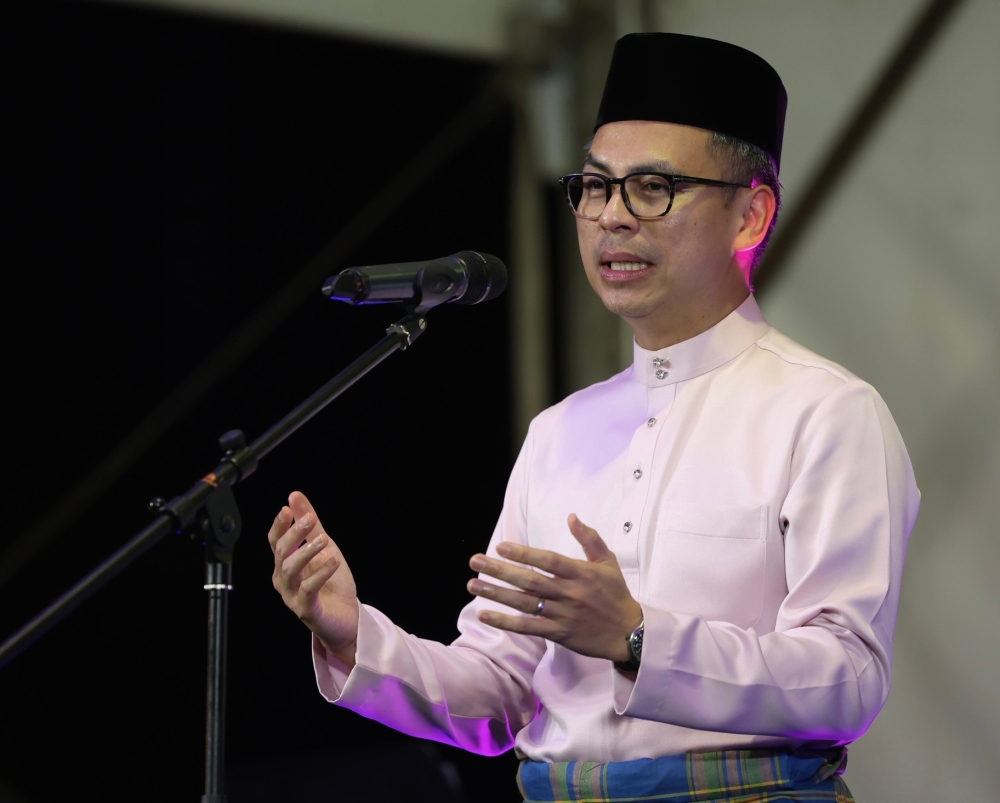 Communications Minister Fahmi Fadzil speaks at the Lembah Pantai Hari Raya Aidilfitri 2024 Open House at IWK Eco Park @ Pantai Dalam in Kuala Lumpur April 21, 2024. — Bernama pic