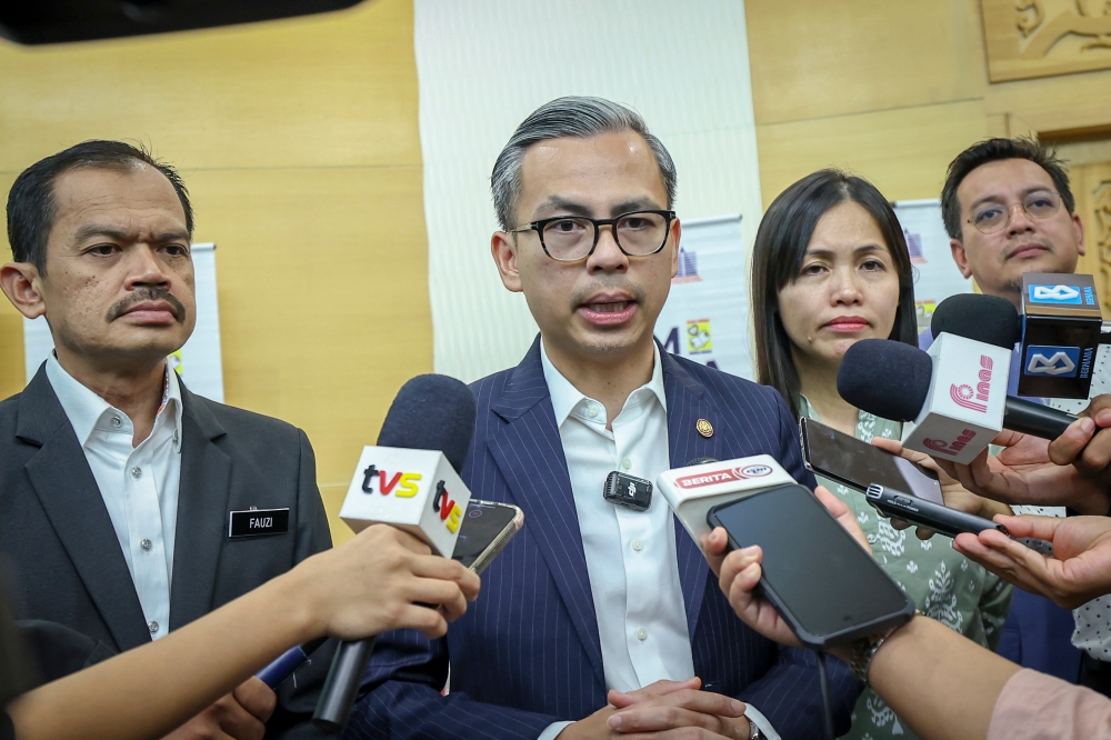 Communications Minister Fahmi Fadzil speaks to the media after launching the ‘Jom Baca Bersama’ 10-minute programme at the level of the Ministry of Communications in Putrajaya April 22, 2024. — Bernama pic
