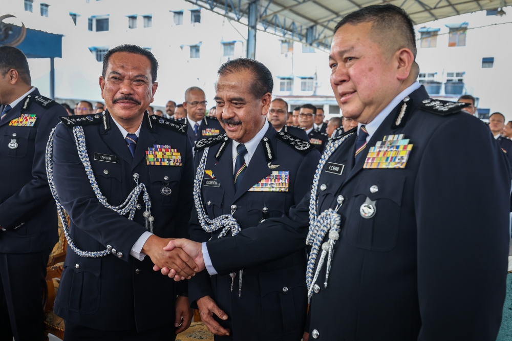 Inspector-General of Police Tan Sri Razarudin Husain with newly appointed Penang police chief Datuk Hamzah Ahmad (left) and the Bukit Aman Narcotics Crime Investigation Department director Datuk Khaw Kok Chin, after the handover ceremony at the State Contingent Police Headquarters, George Town, April 22, 2024. — Bernama pic 