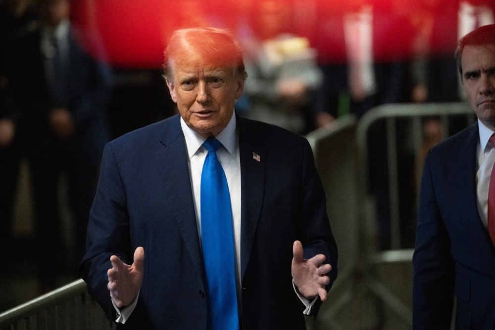 Former US president and Republican presidential candidate Donald Trump speaks to the press during his trial for allegedly covering up hush money payments linked to extramarital affairs at Manhattan Criminal Court in New York April 22, 2024. — Picture by Victor J. Blue / POOL via AFP