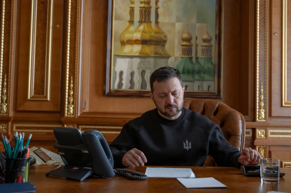 This handout photograph taken and released by the Ukrainian Presidential Press Service April 22, 2024 in Kyiv shows Ukrainian President Volodymyr Zelensky talking on the phone with US President Joe Biden. — Handout by Ukrainian Presidential Press Service via AFP