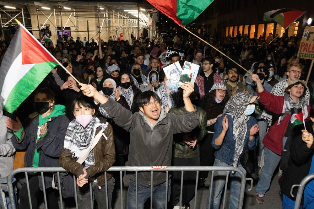Pro-Palestinian students and activists protest the Israel-Hamas war on the campus of New York University (NYU) in New York April 22, 2024. — AFP pic