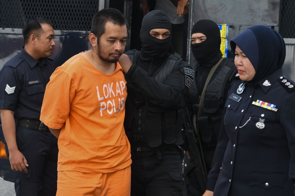 The suspect involved in a shooting incident at the Kuala Lumpur International Airport (KLIA) Terminal 1 Arrival Hall, being brought to the Kota Baru Magistrate's Court April 22, 2024 for an application for extension of remand. — Bernama pic